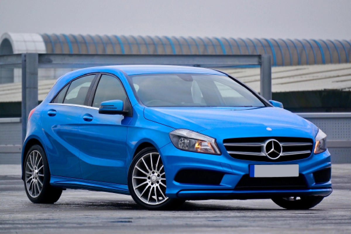 A blue car is parked in the parking lot.