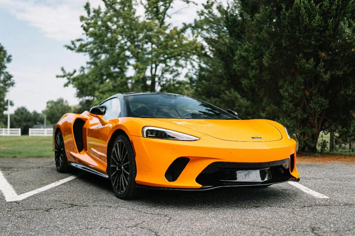 A yellow sports car is parked on the street.