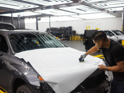 A man is working on a car in a garage.