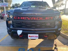 A black truck with red letters on the hood.